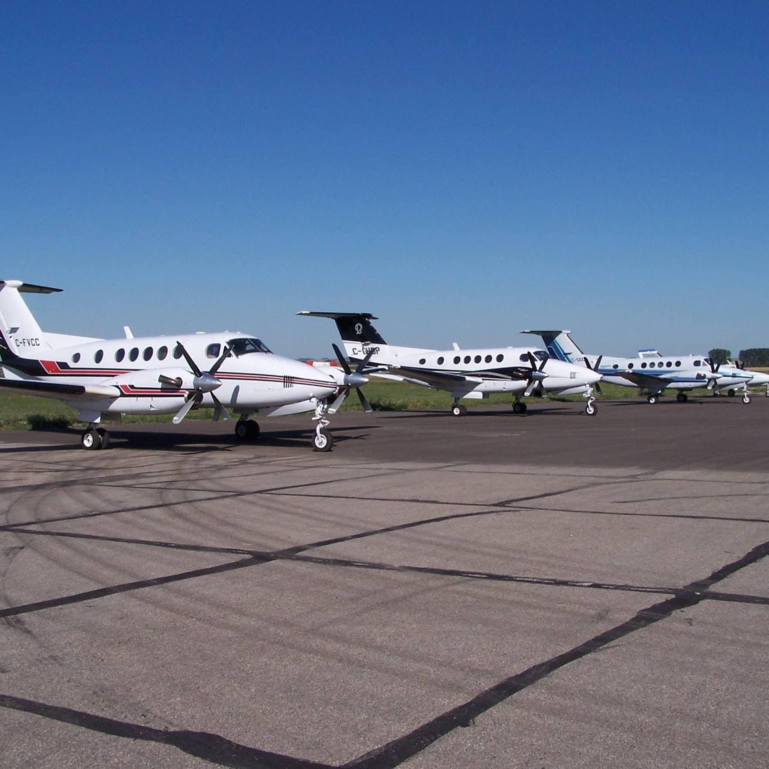 Three Good Spirit Air King Air aircraft on the summer ramp
